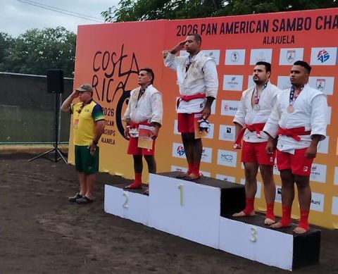 Gustavo Assis no lugar mais alto do pódio prestando continência